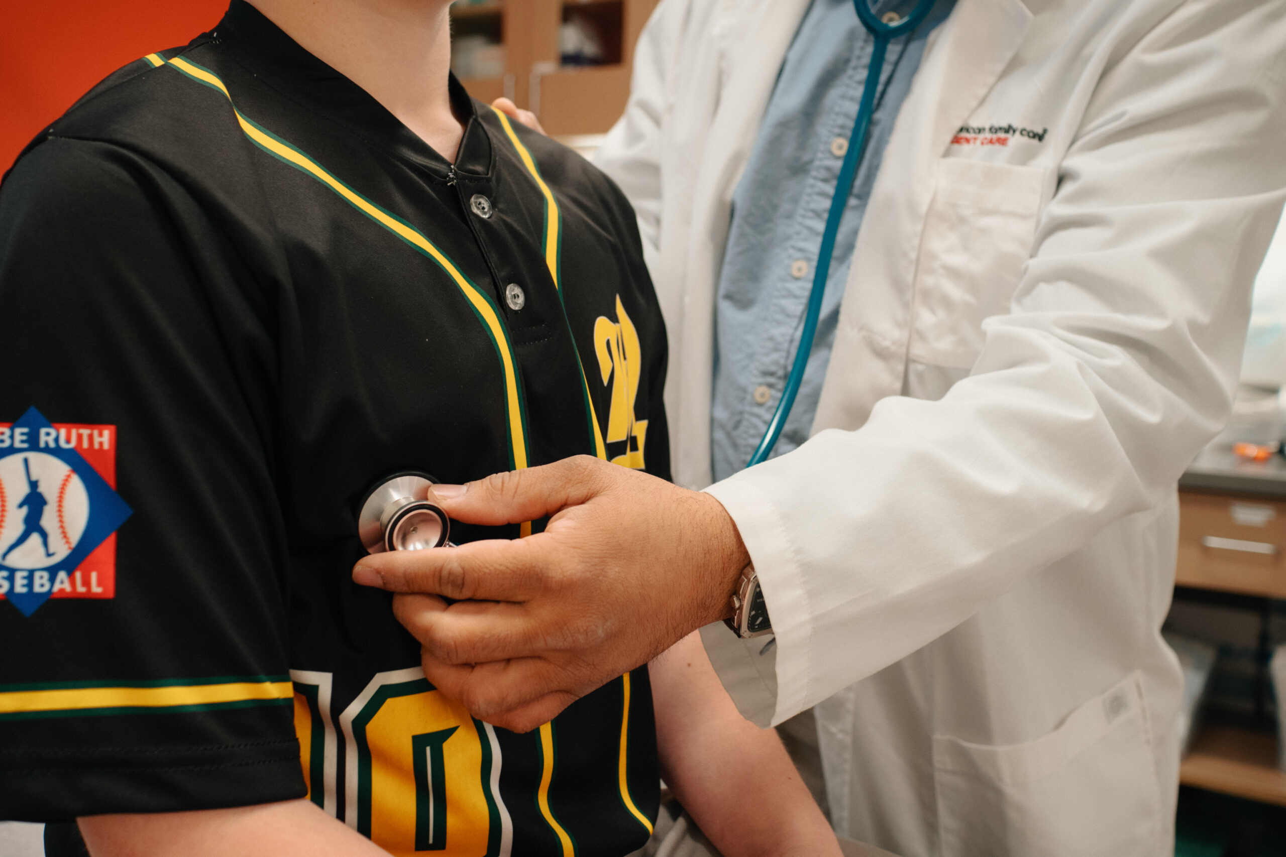 A young athlete has his vitals taken by a medical provider during their required annual sports physical.